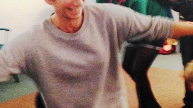 person with arms stretched out smiling