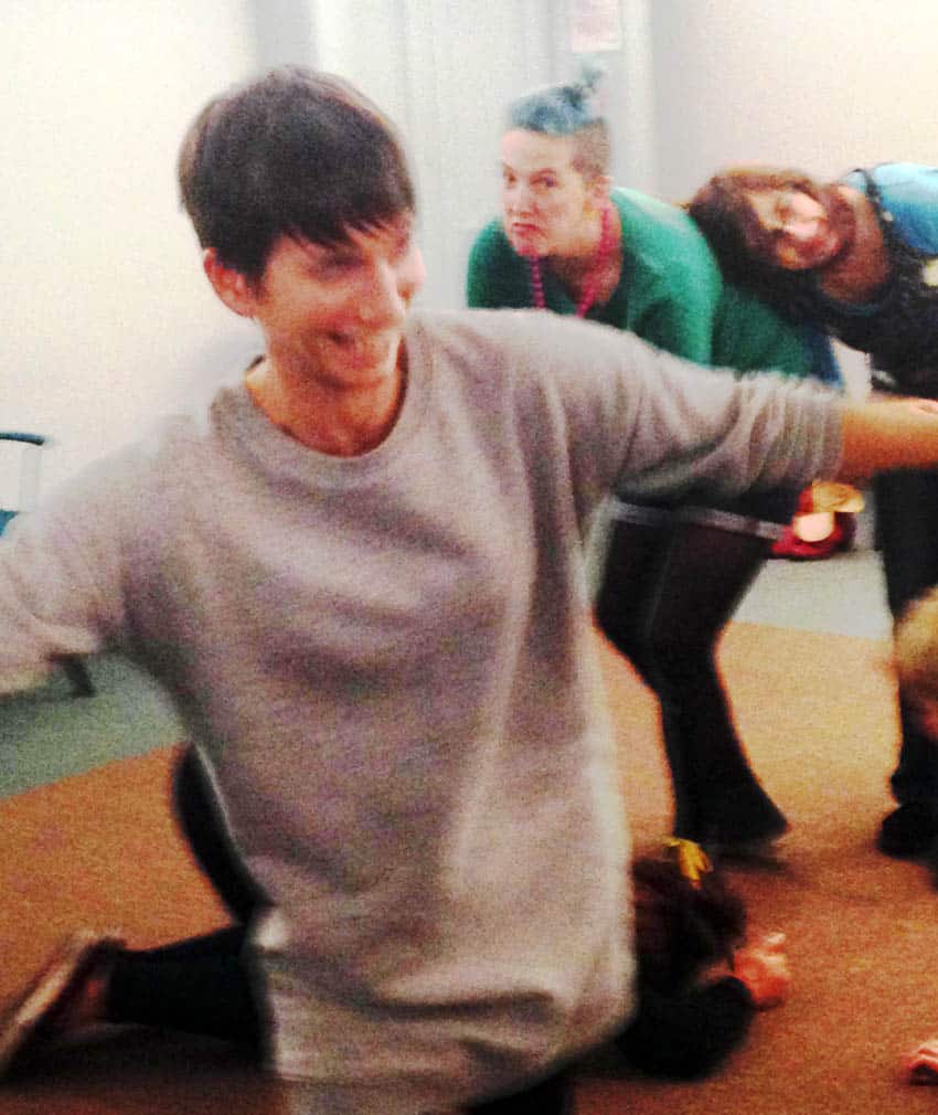 person with arms stretched out smiling
