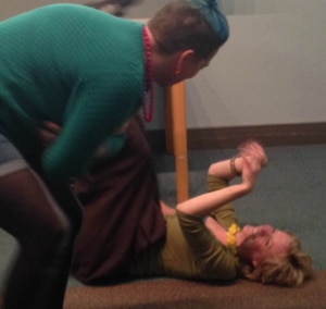 two people during workshop, one person is laid on the floor