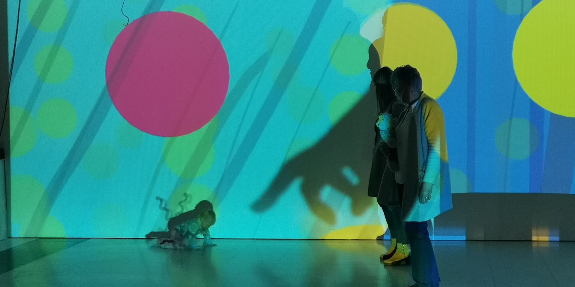 People making silhouettes against wall during workshop